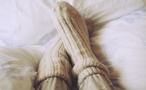 Warm socks against cold feet in bed